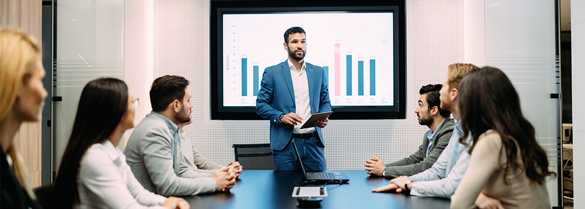Man presenting with chart at business meeting