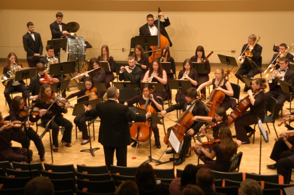 Full orchestra playing concert in recital hall