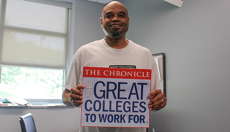 slippery rock university employees hold sign depicting great colleges to work for logo