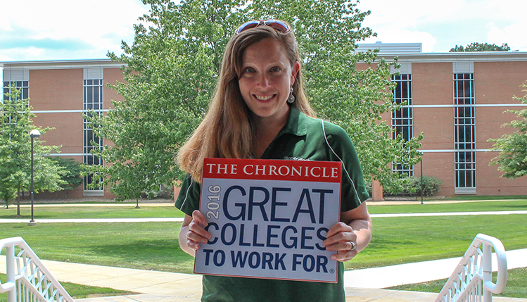 slippery rock university employees hold sign depicting great colleges to work for logo