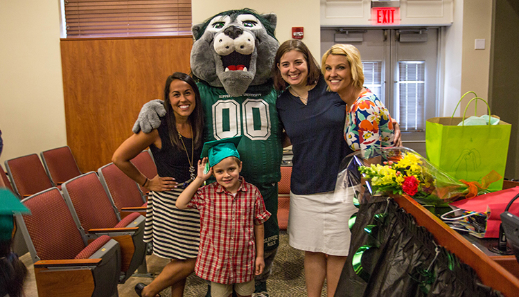 SRU Mascot Rocky with a child and several teachers