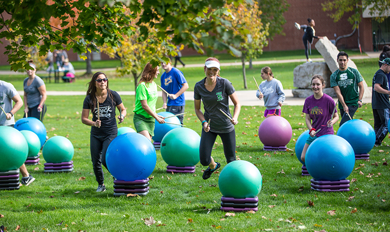 exercise science students drumming with yoga balls