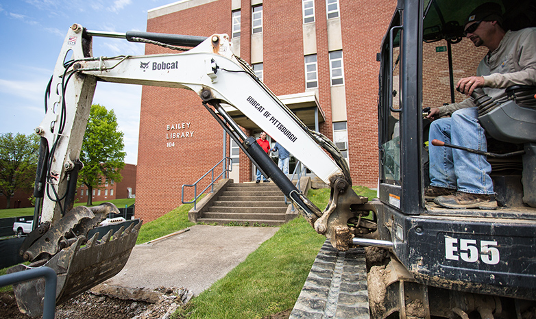 bulldozer tearing up sidewalk at bailey library