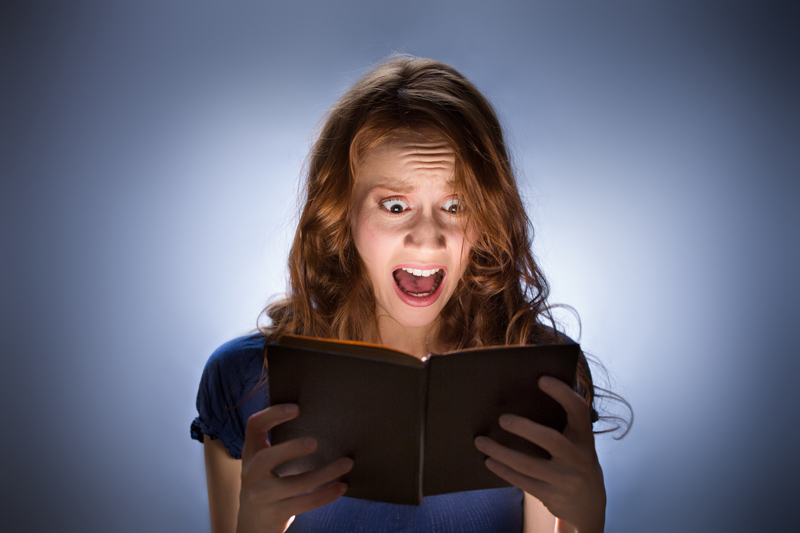 Woman reading scary book