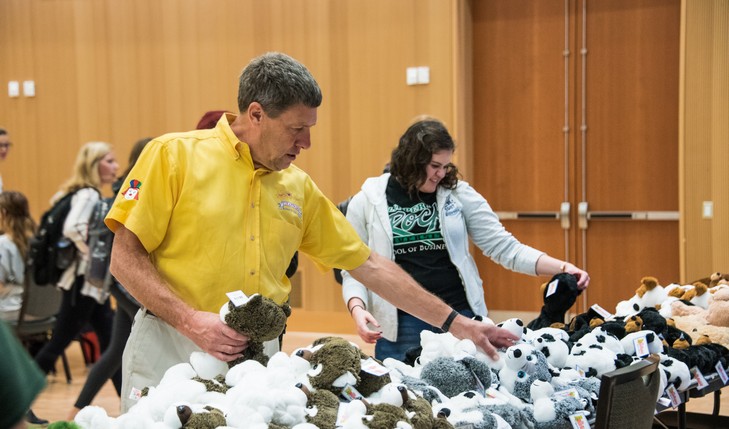 Faculty and student pick out an animal