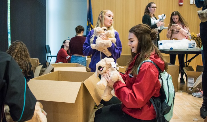 Students take stuffed animals out of boxes
