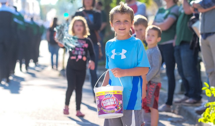 Child holds candy bucket