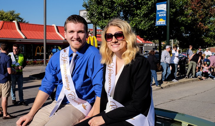 Homecoming court members ride in parade