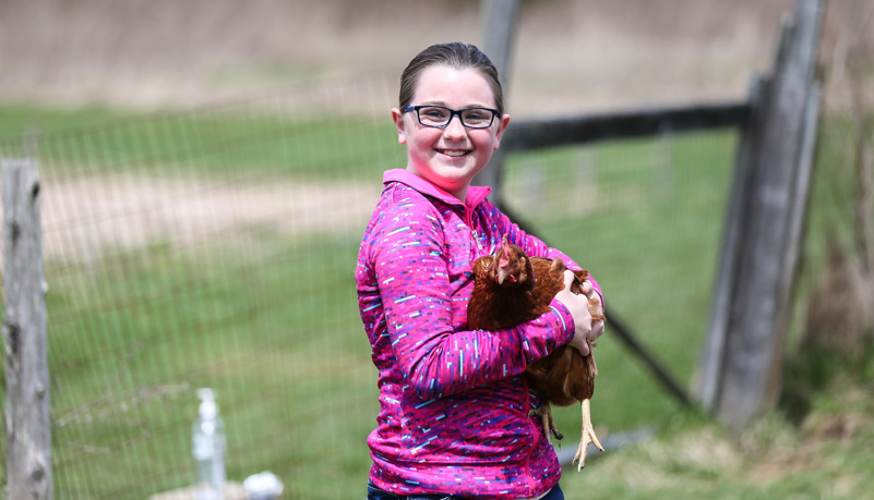 Girl holding a chicken