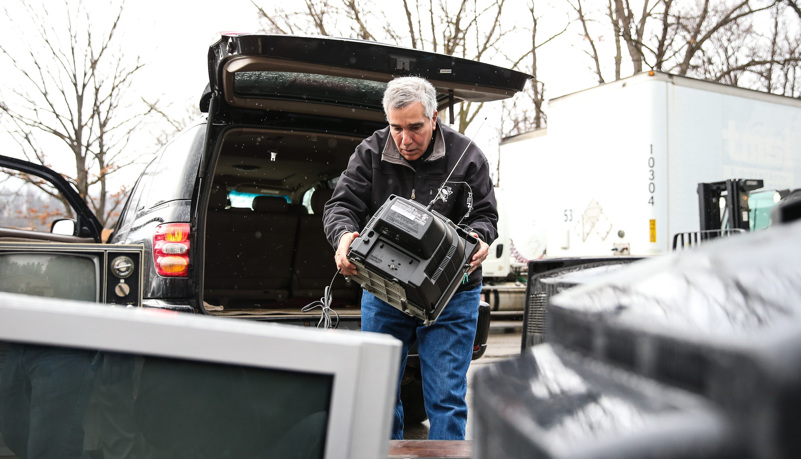 Man unloading recycled electronics