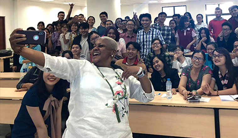 Professoer takes a selfi with students
