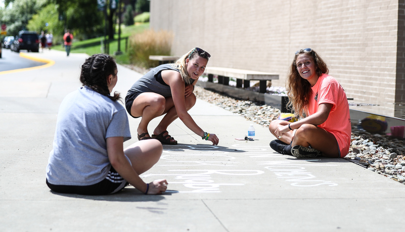 Students drawing with chalk