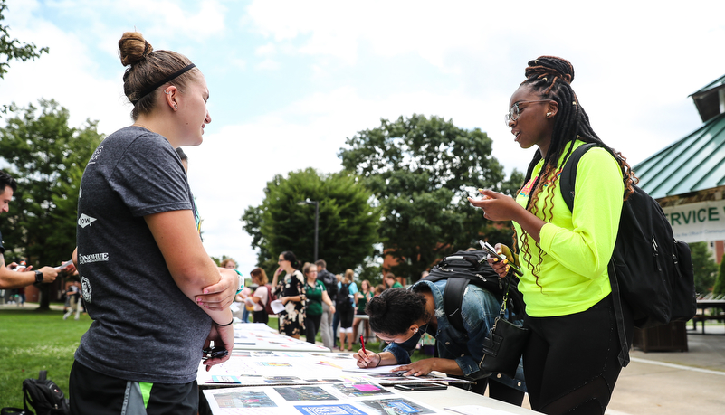 Student talking with a commuity organization member