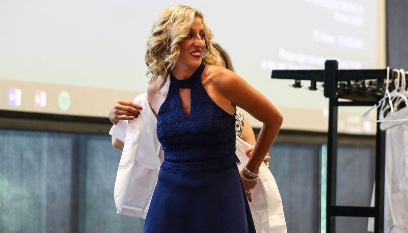 Student receives her white coat