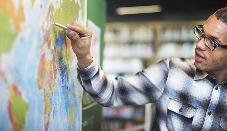 Professor teaching at a map