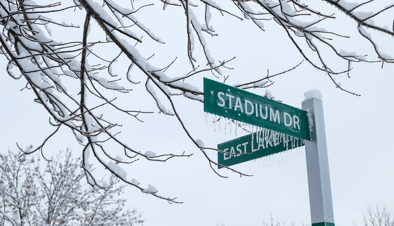 Stadium road signs covered in ice and snow