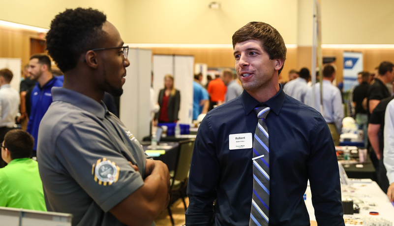 students talking to employers