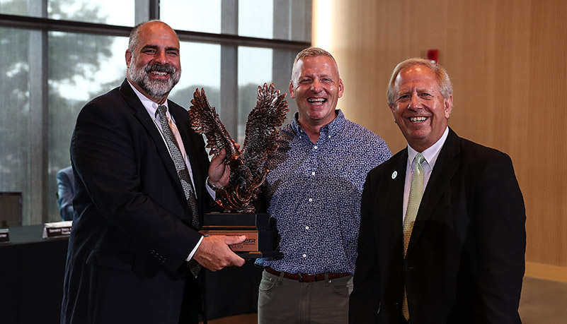 PResident Behre, Gary Clark, and Jeff Smith with the freedom award