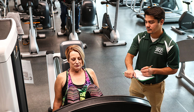 A professor working with a student personal trainer