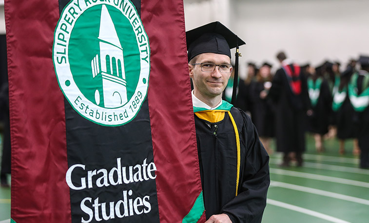 Graduate student holding the banner