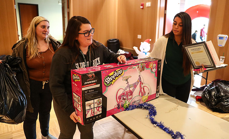 Holiday gifts collected at the University Program Broad’s Season of Giving event at Slippery Rock University include donations for 75 children from various Butler County families in need through SRU’s Elf Project.
