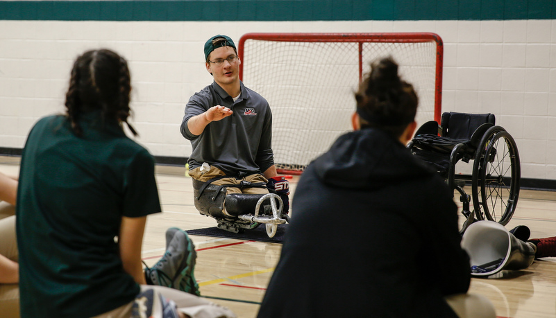 Students learning about sled hockey
