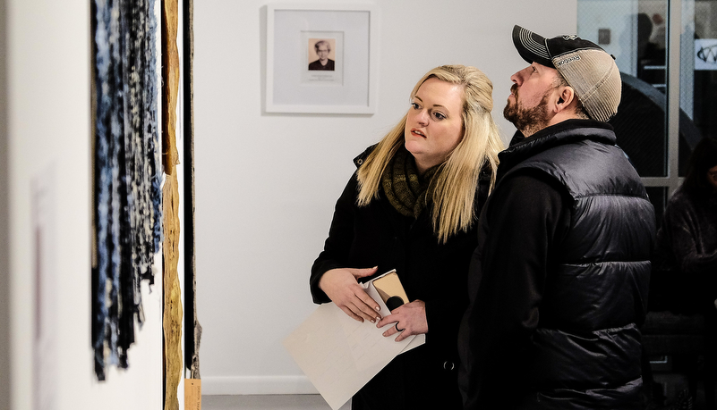 a couple looking at art on display