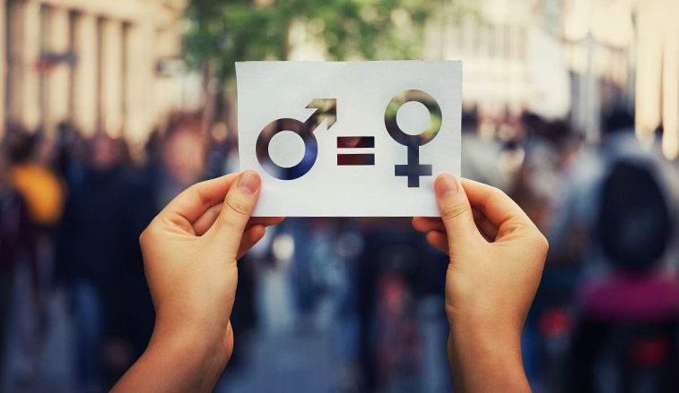 Hands holding a card representing gender equality