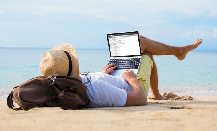 Reading a laptop on a beach