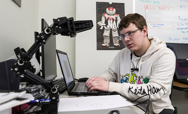 Student working with a robot