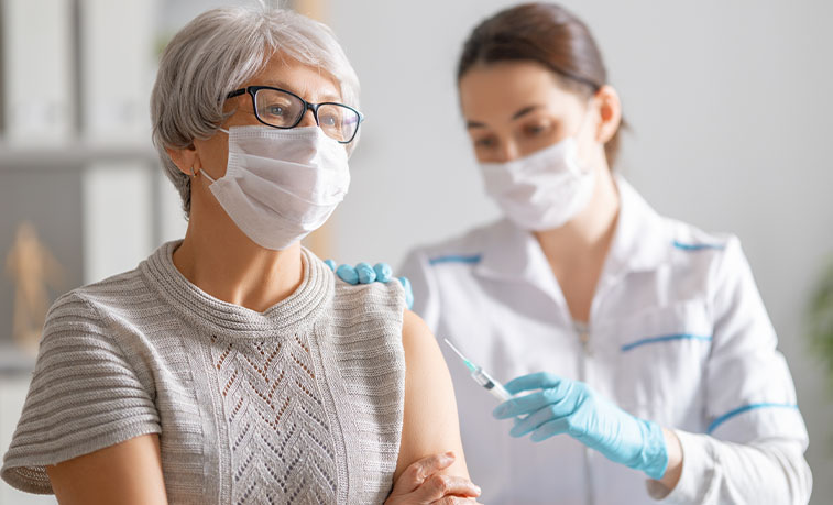 Elderly women receiving a vaccine