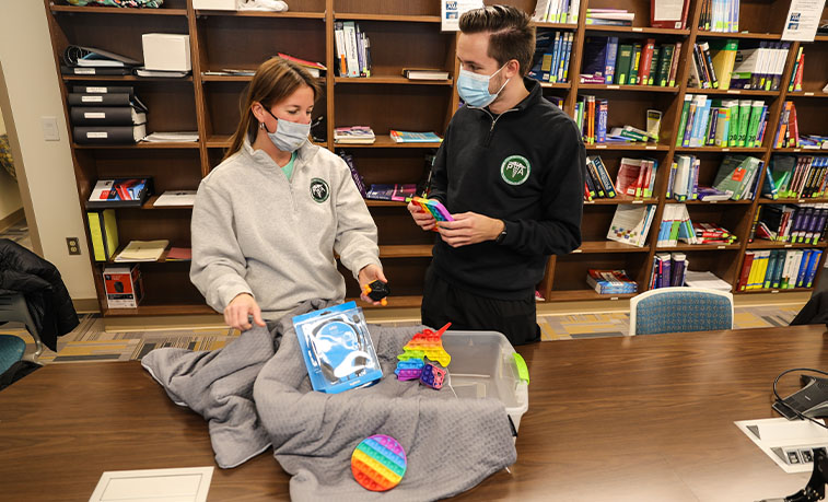 Student and professor assembling a sensory kit