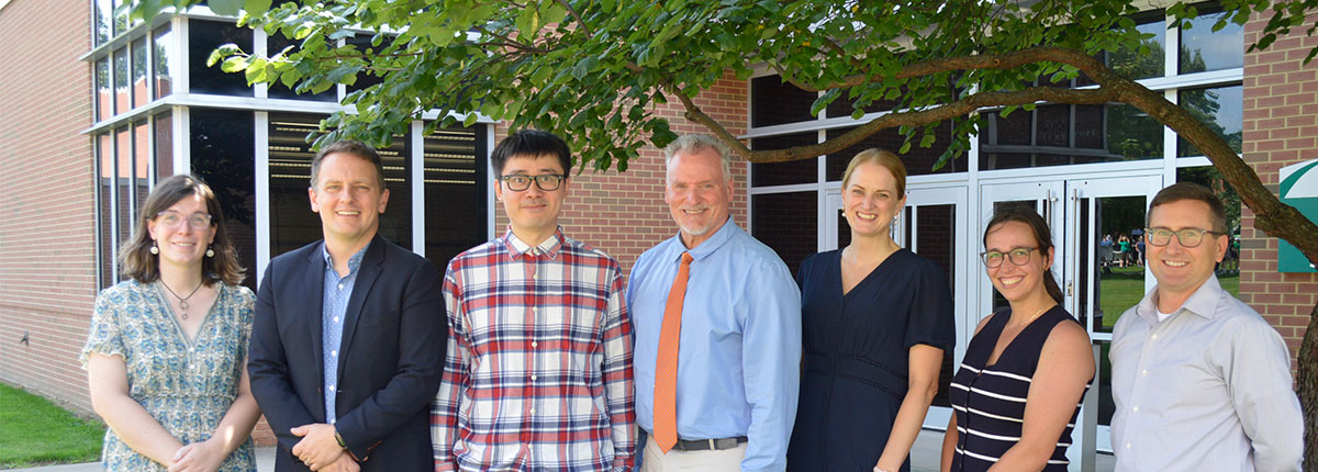 History Faculty standing in front of a building.