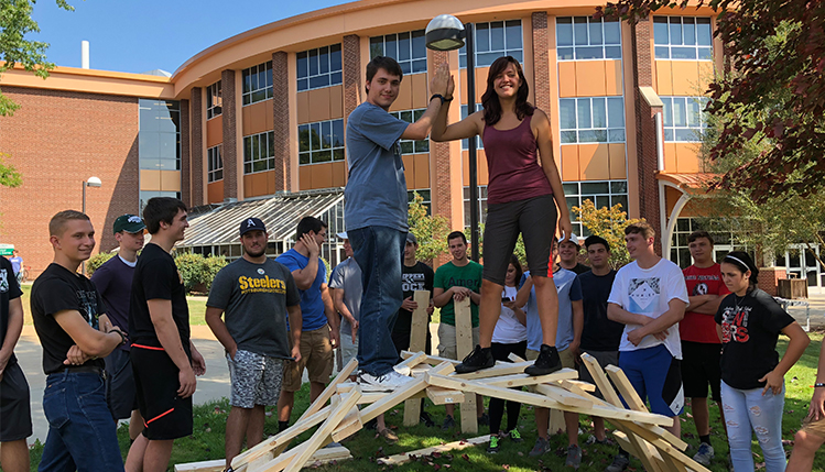 Students standing on top of their made Da Vinci bridge