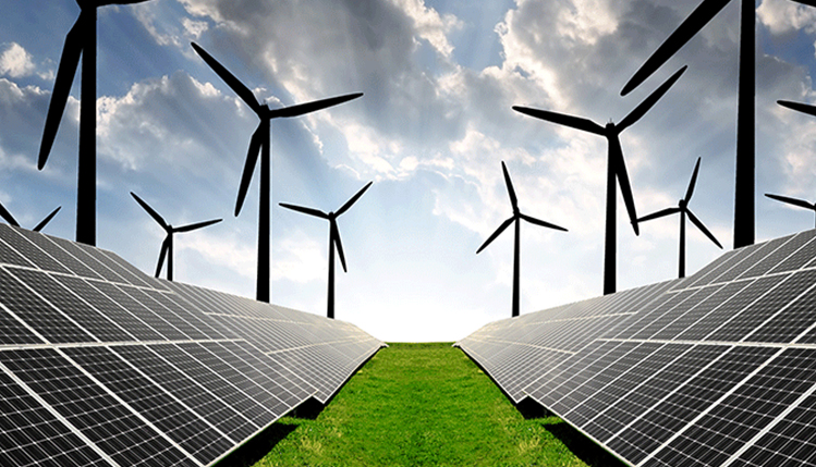 Windmills and solar panels with a distant sunrise