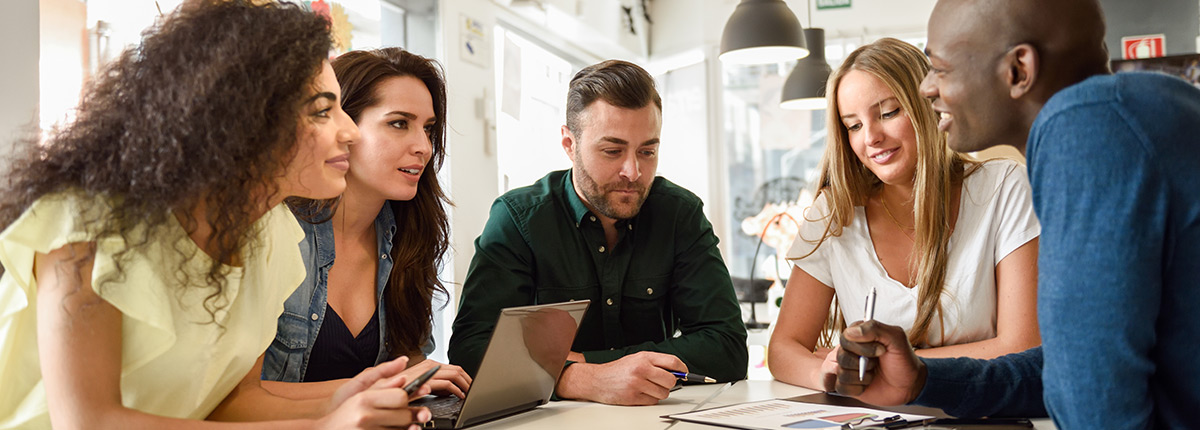 Young professionals collaborating at a table.