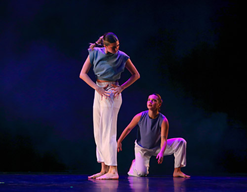 Two SRU student doing a performative dance on stage