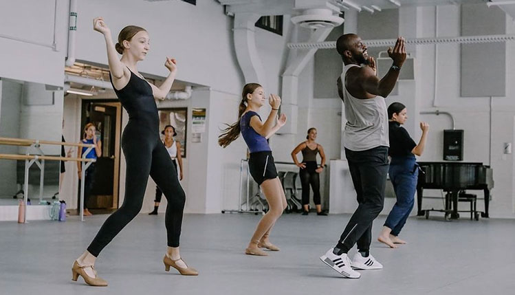 Students learning from choreographer