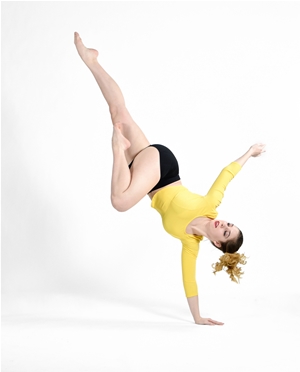 Dance student performs an inversion