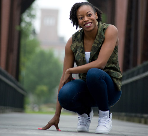 Shakia Barron posed crouched down on a bridge