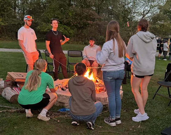 Photo of students around a campfire