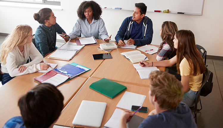 Students sitting around table