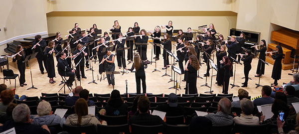 Flute choir performing in a concert hall