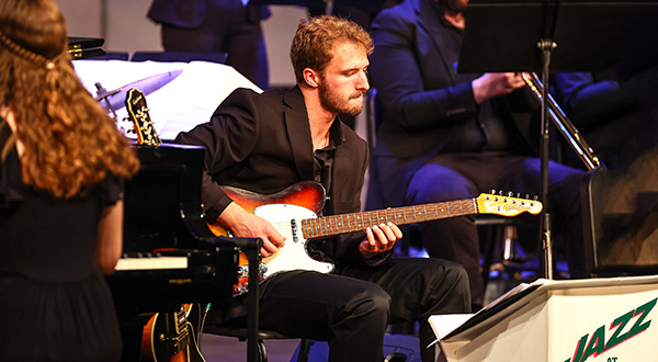Musicians playing on a stage.