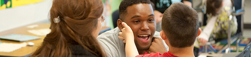 Student teaching a child