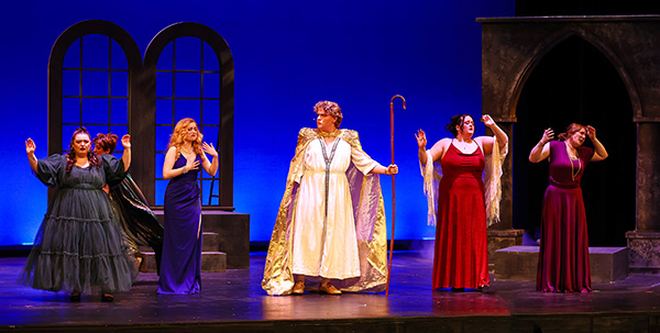 A group of Opera perfomers on a stage. 