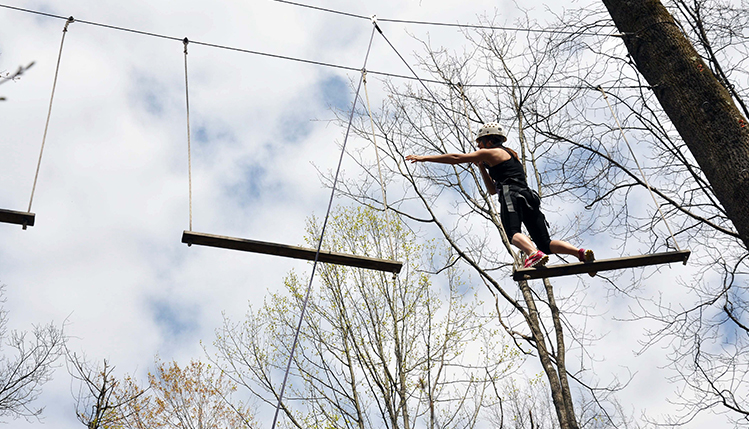 Student walks on rope