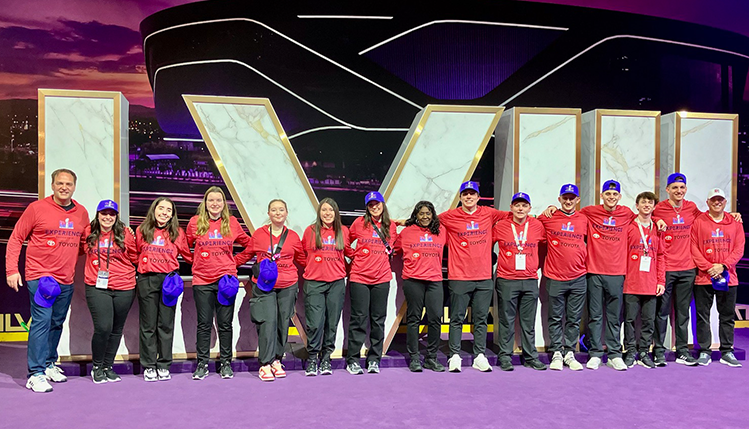 Students standing in front of Super Bowl LVIII sign
