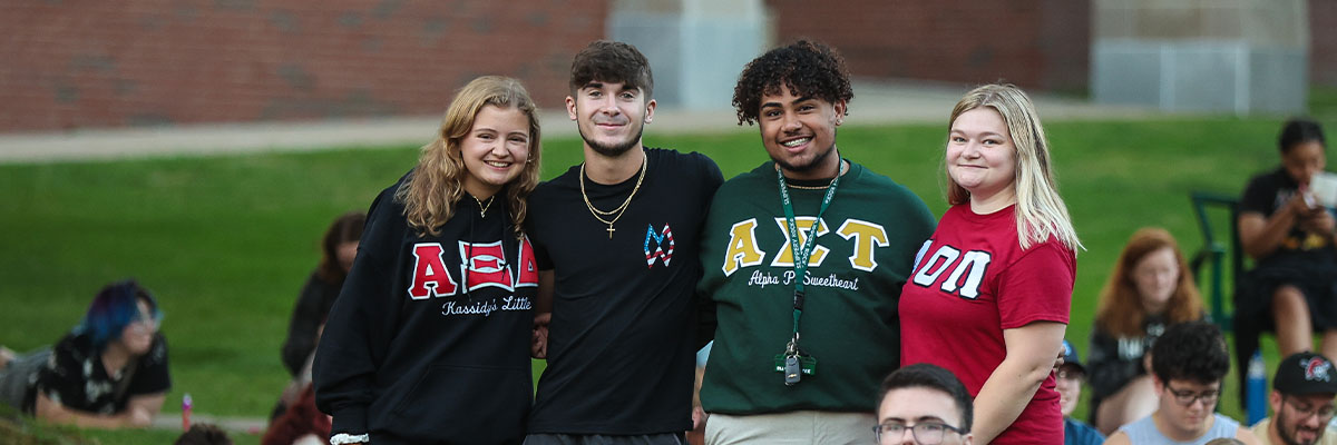 Student smiling sitting together on SRU campus 