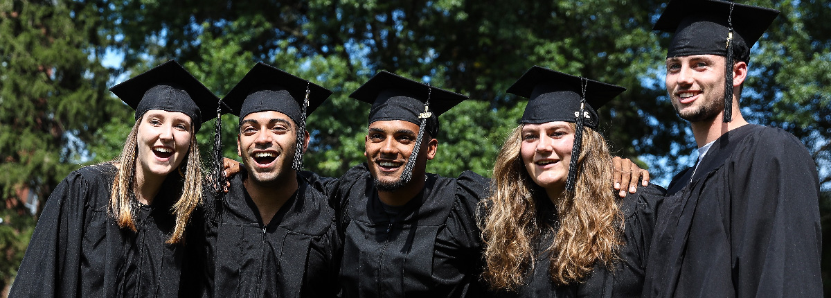 An image of 5 students wearing a cap and gown.